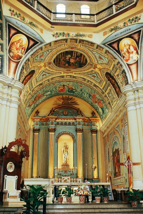 Free A vibrant, classic church interior with ornate religious art and architectural details. Stock Photo