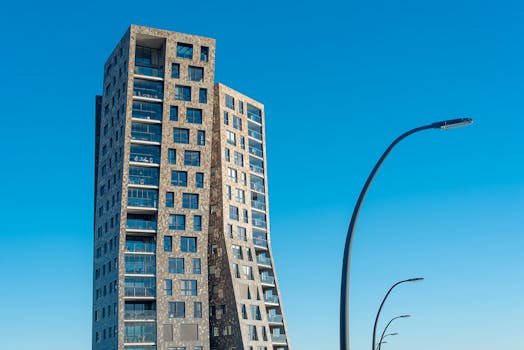 Stunning modern tower with unique design against a clear blue sky, showcasing contemporary architecture.