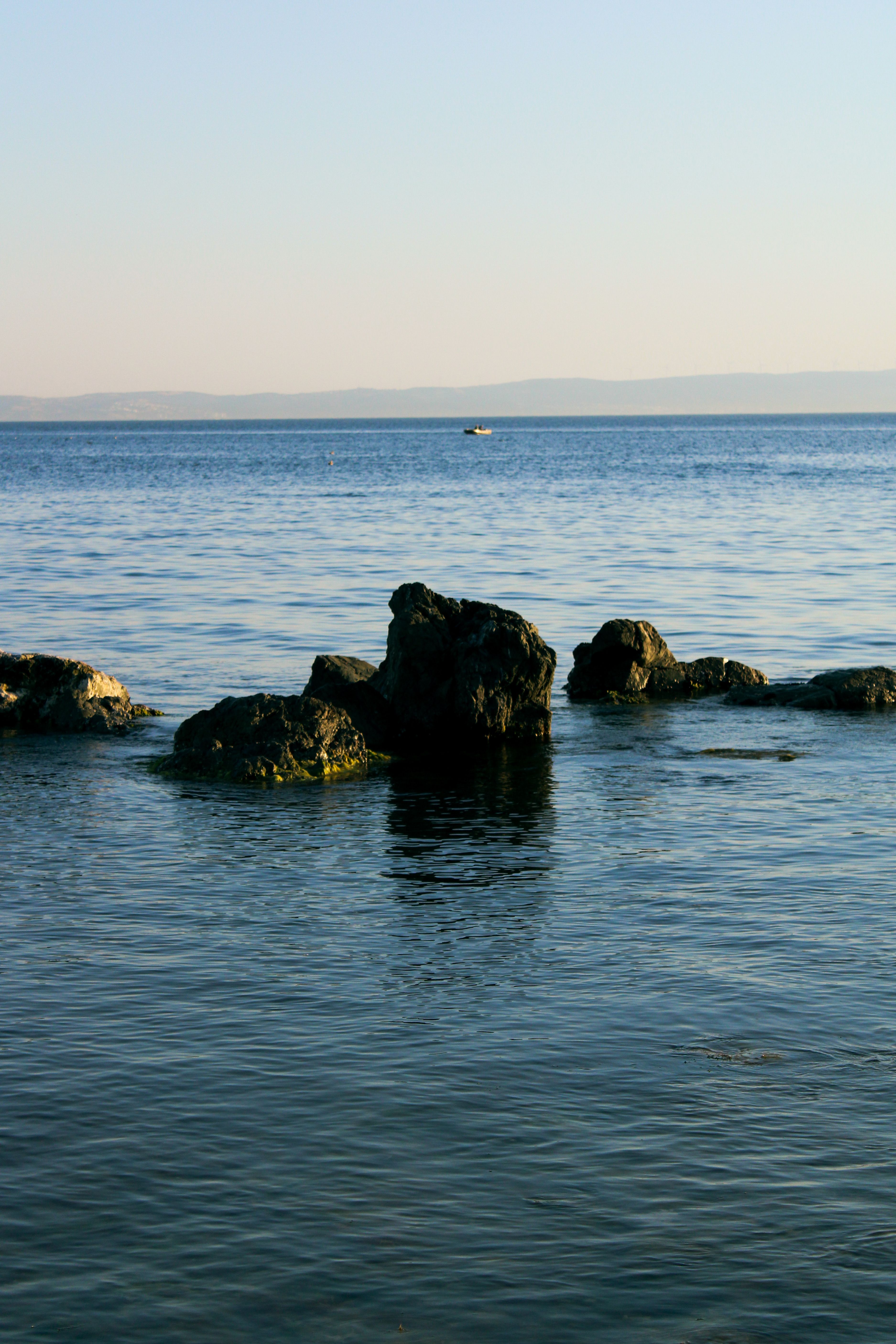 Serene Coastal Rocks at Sunset · Free Stock Photo