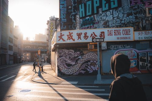 Free A vibrant street scene in New York City featuring urban graffiti and morning light. Stock Photo