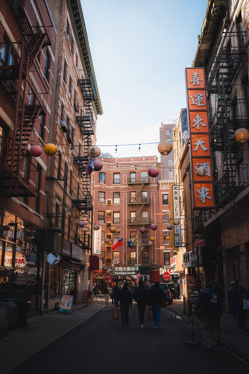 Free Vibrant street view of Chinatown, NYC with lanterns and signs visible. Stock Photo