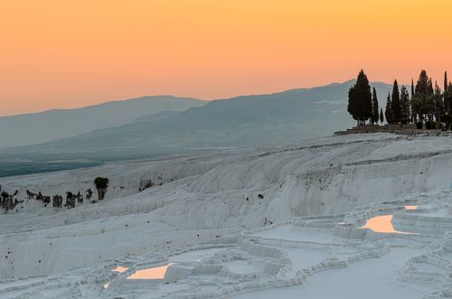 Free Stunning view of Pamukkale's travertine terraces at sunset, capturing the natural beauty. Stock Photo
