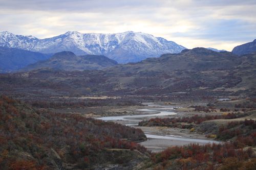 Free Breathtaking view of a winding river in a mountainous landscape under a bright sky. Stock Photo