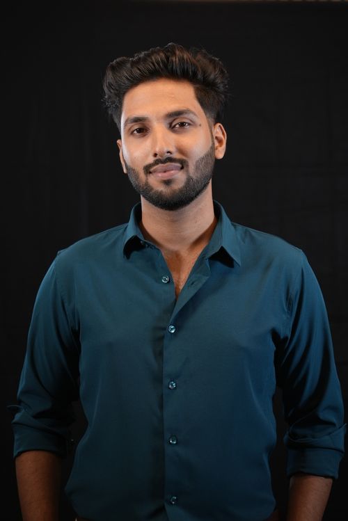 Free Studio portrait of a confident South Asian man in a sea green shirt. Stock Photo