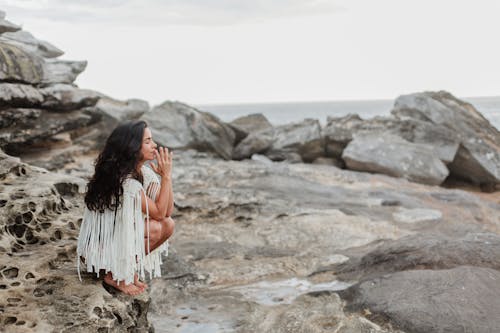 Photo Of Woman Sitting On Rock
