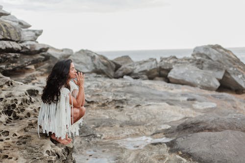 Photo Of Woman Sitting On Rock 