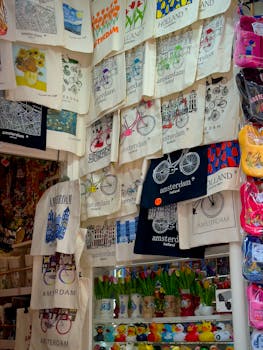 A vibrant collection of Amsterdam-themed tote bags and souvenirs in a shop.