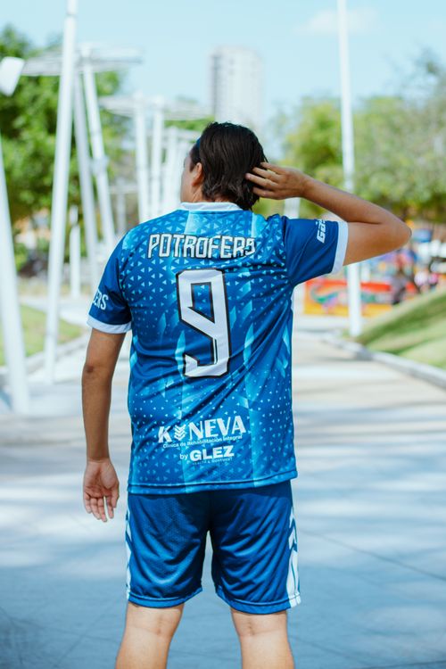Free Individual in sporty blue jersey with number nine outdoors on a sunny day. Stock Photo
