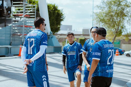 Group of young men in blue jerseys discussing strategy outdoors in Puebla, Mexico.