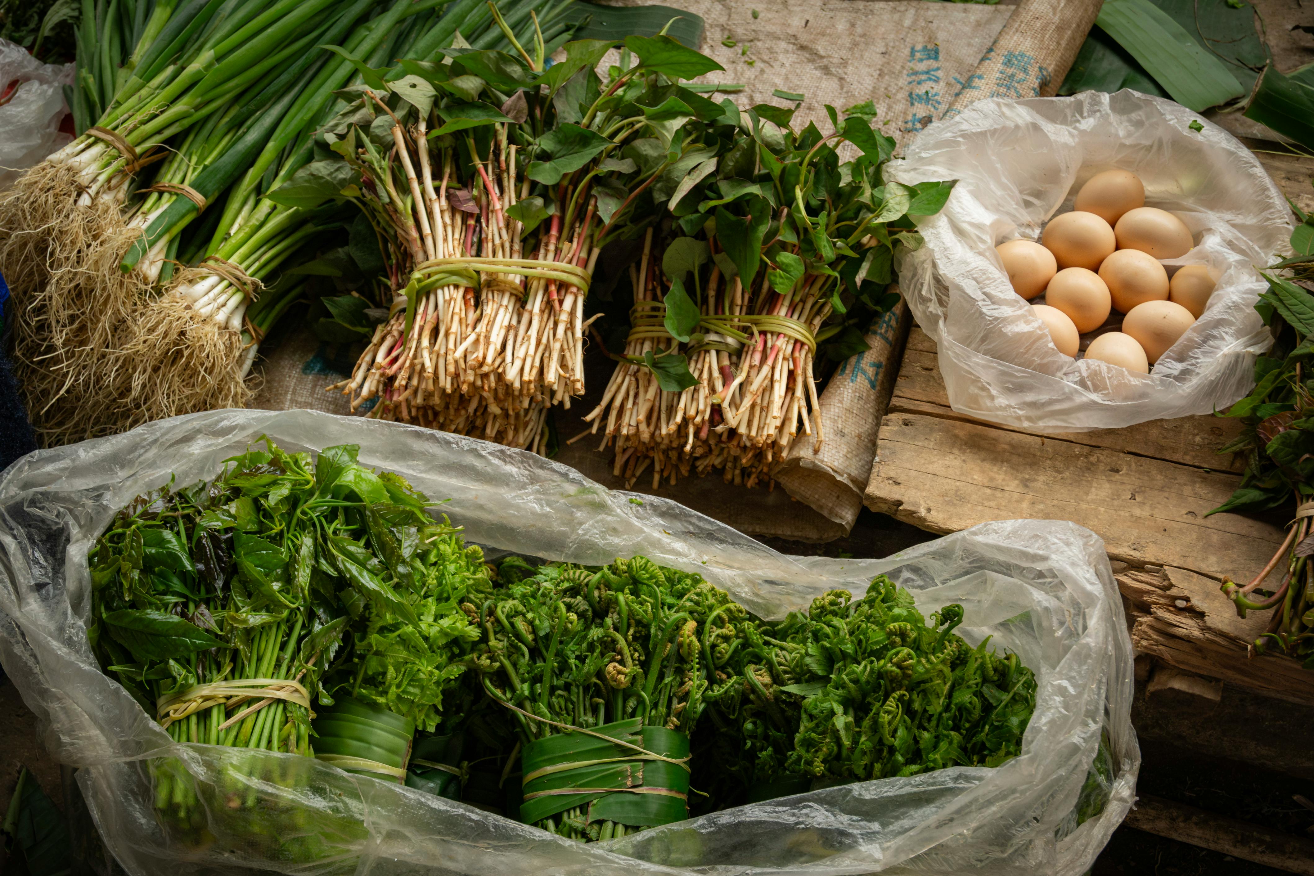 Colorful fresh produce and eggs at a local market in Yunnan, China.