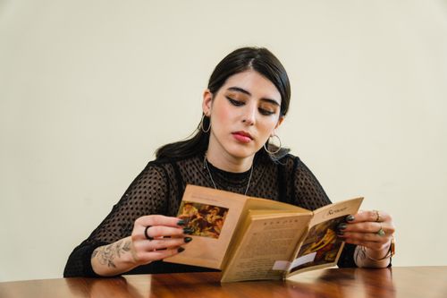 Free A young woman enjoying a book in a stylish café in Culiacán, Mexico. Stock Photo