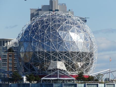 Capture of geodesic dome against Vancouver cityscape with clear skies.