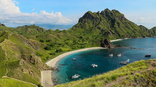 Free Explore the picturesque bay of Padar Island with its lush hills and turquoise waters. Stock Photo