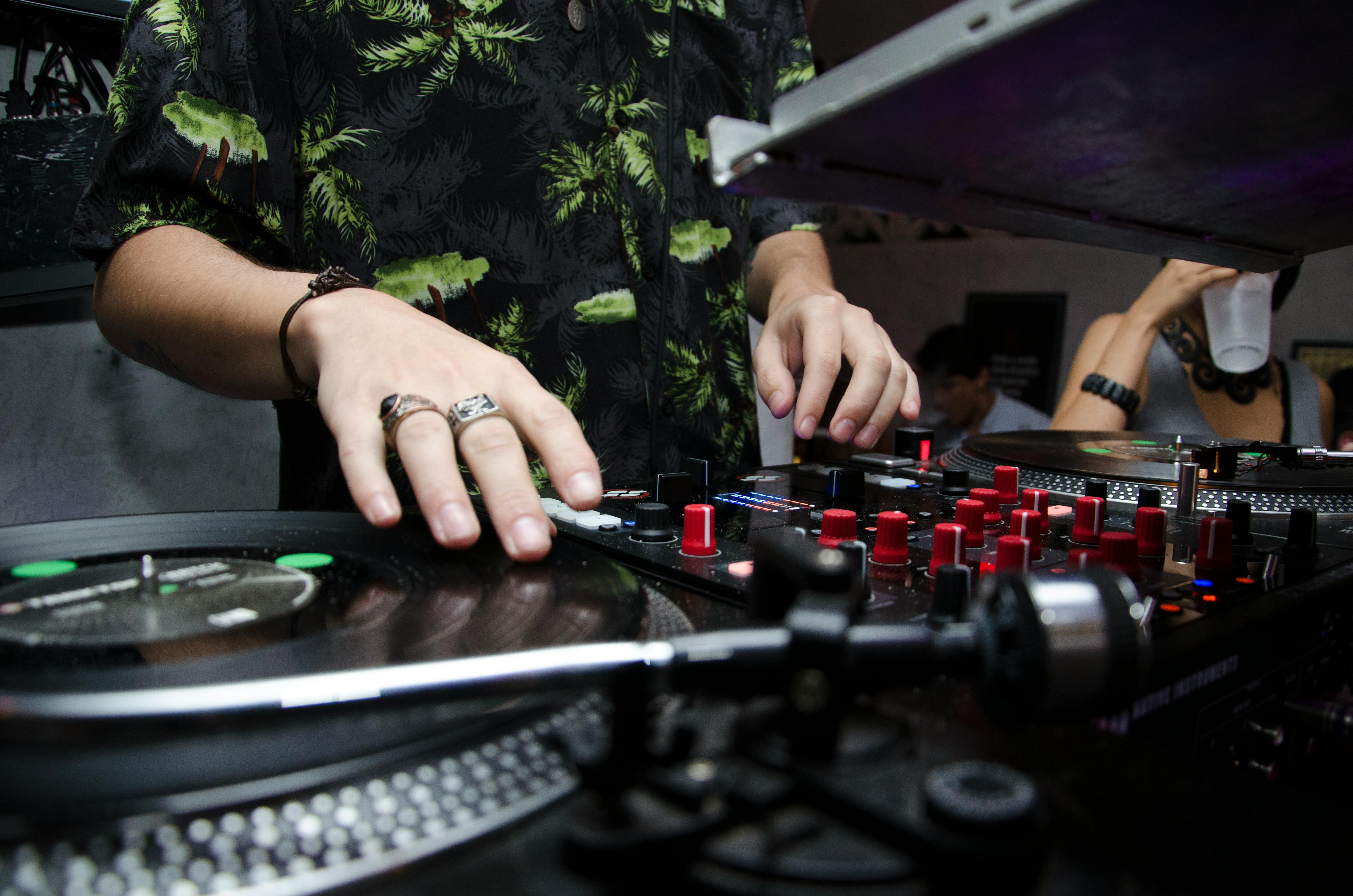 A person playing a DJ mixer