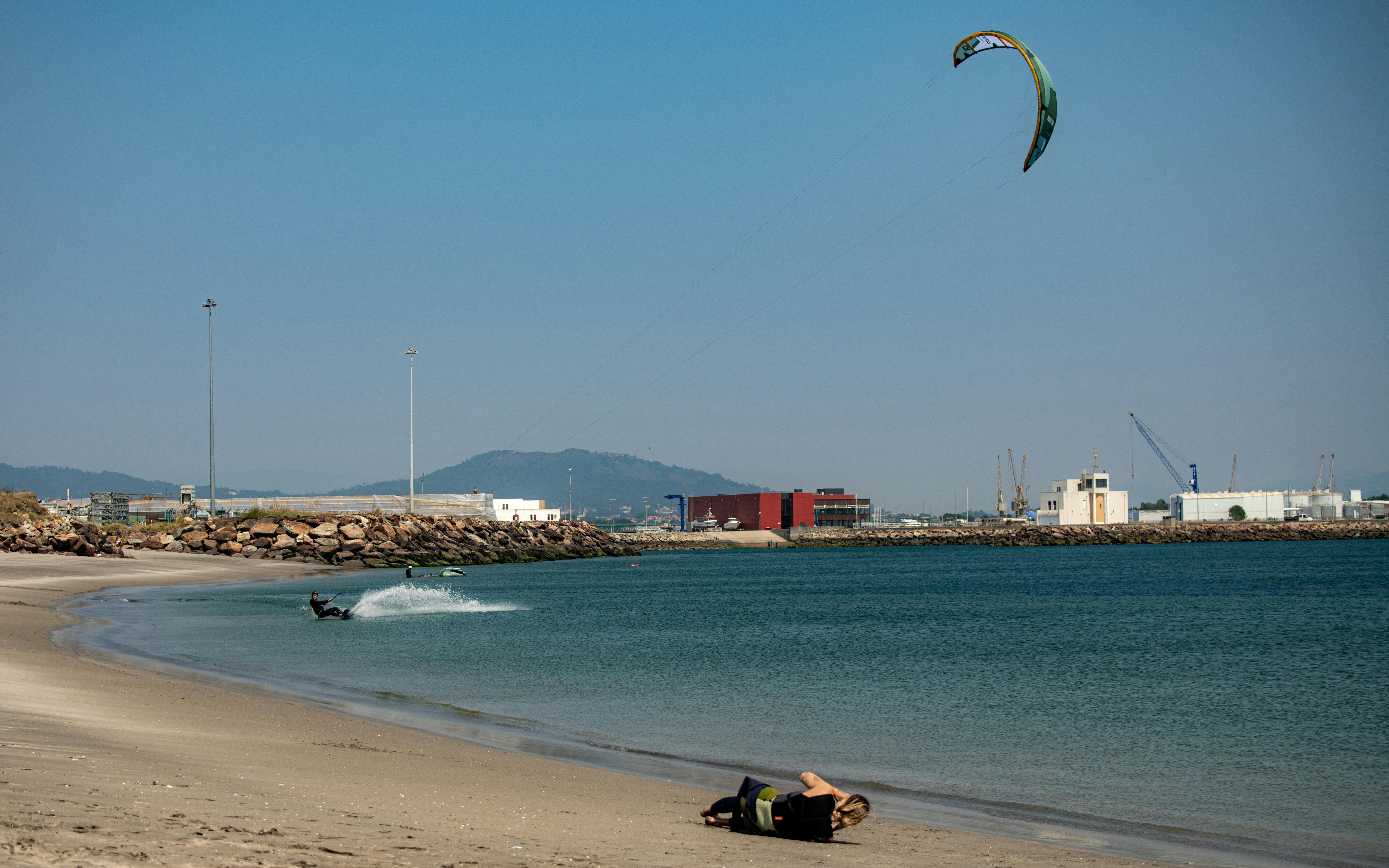 Dynamic kitesurfing scene at Viana do Castelo beach, Portugal, highlighting adventure and tranquility.