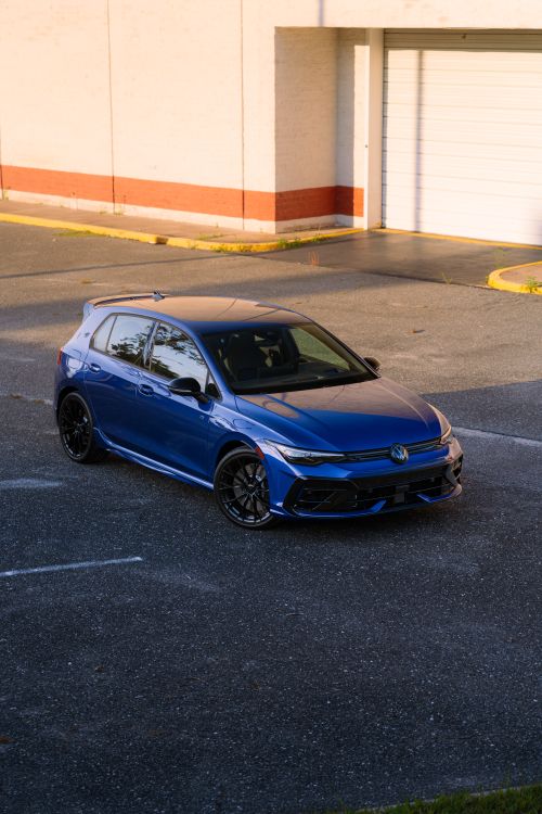 Free Modern blue hatchback parked outdoors in an urban setting during the day. Stock Photo