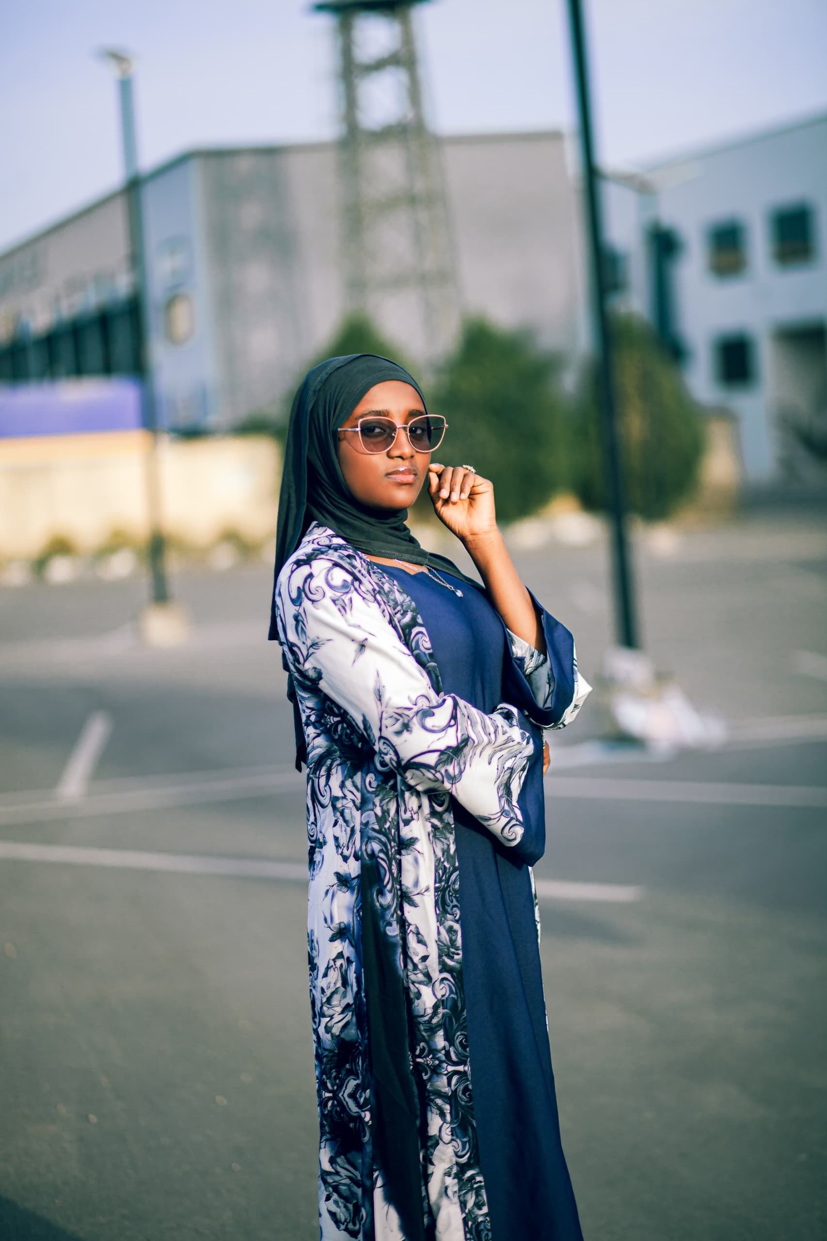 Elegant Woman Posing Outdoors in Stylish Attire · Free Stock Photo