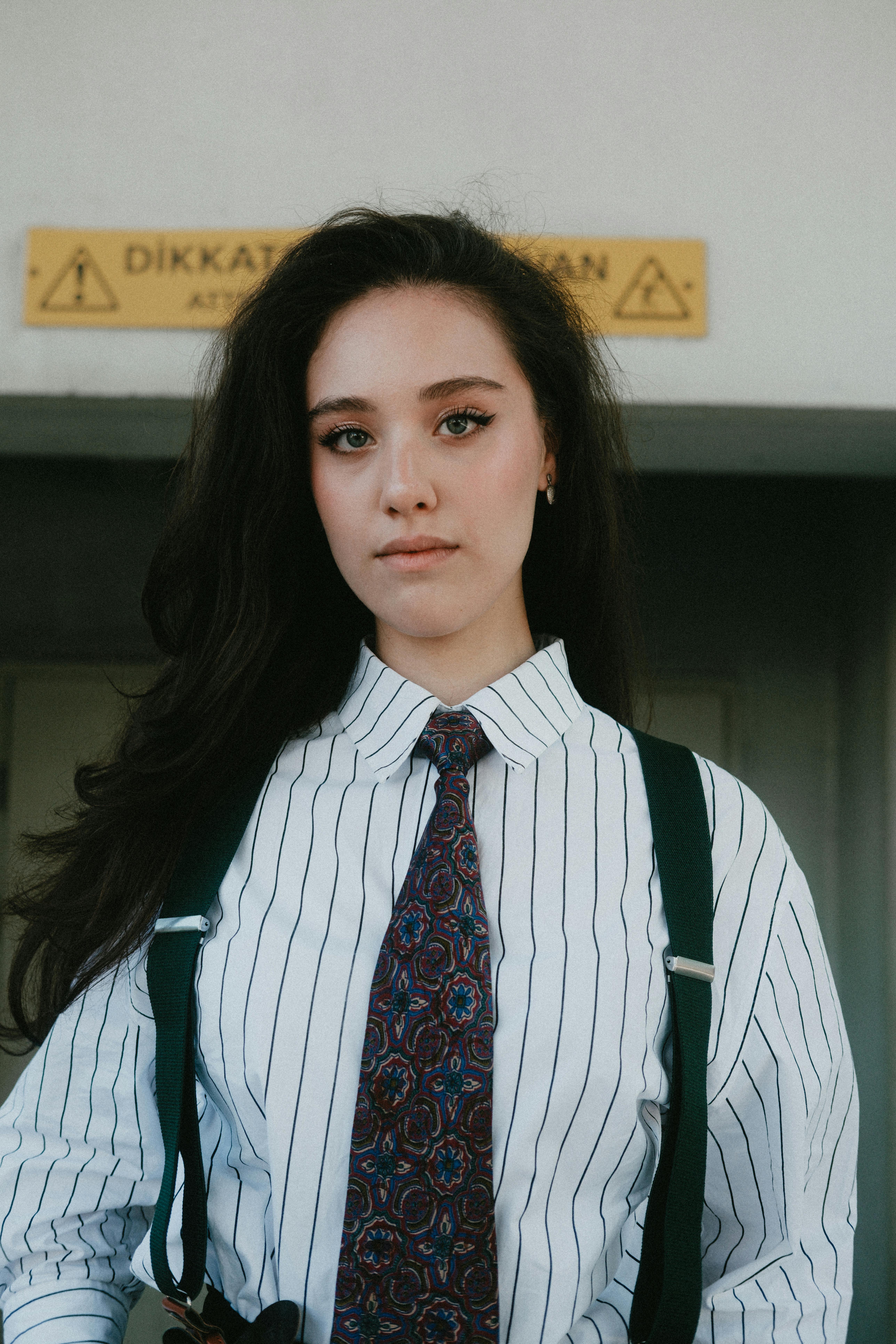 Young woman in formal business attire standing confidently indoors.