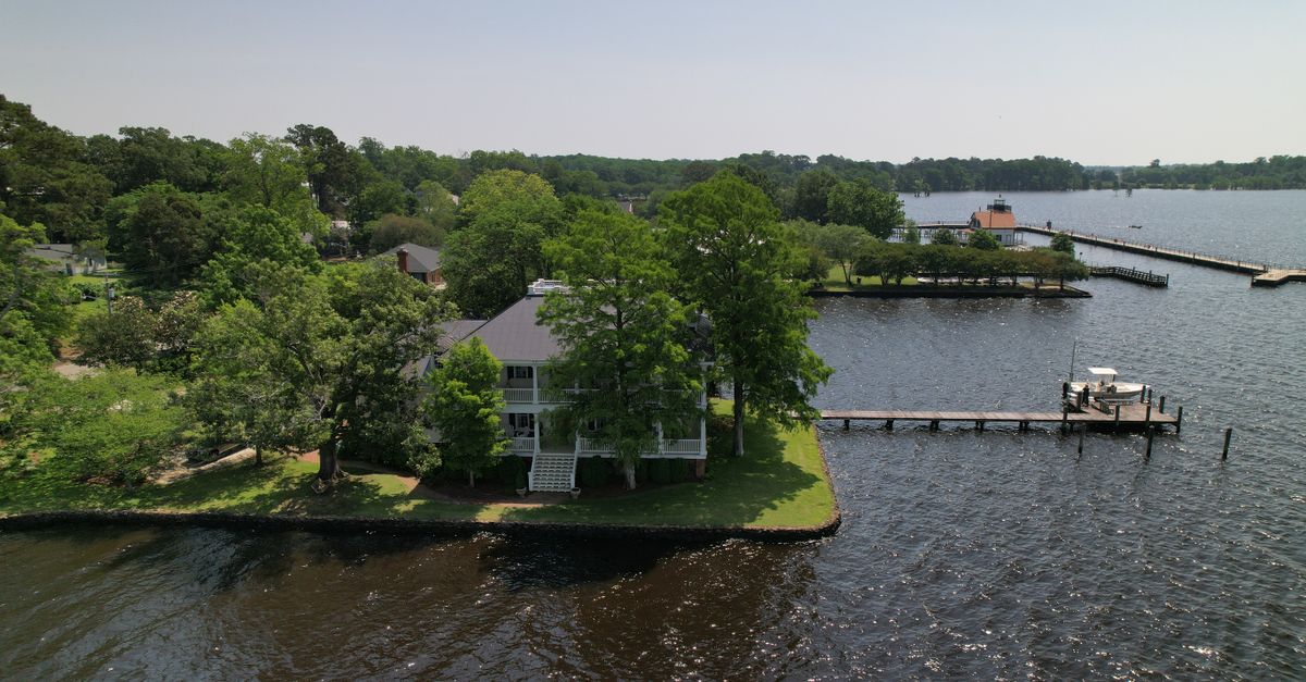 Stunning aerial shot of a serene waterfront property and dock in North Carolina.