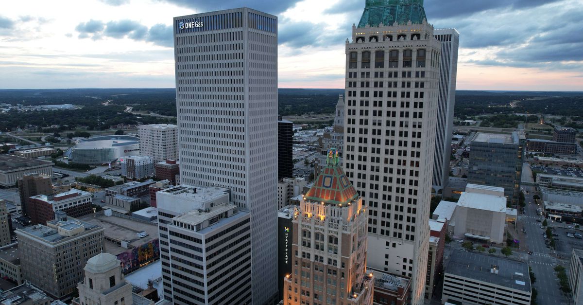 Aerial view of Tulsa cityscape with prominent ONEOK Building at twilight.
