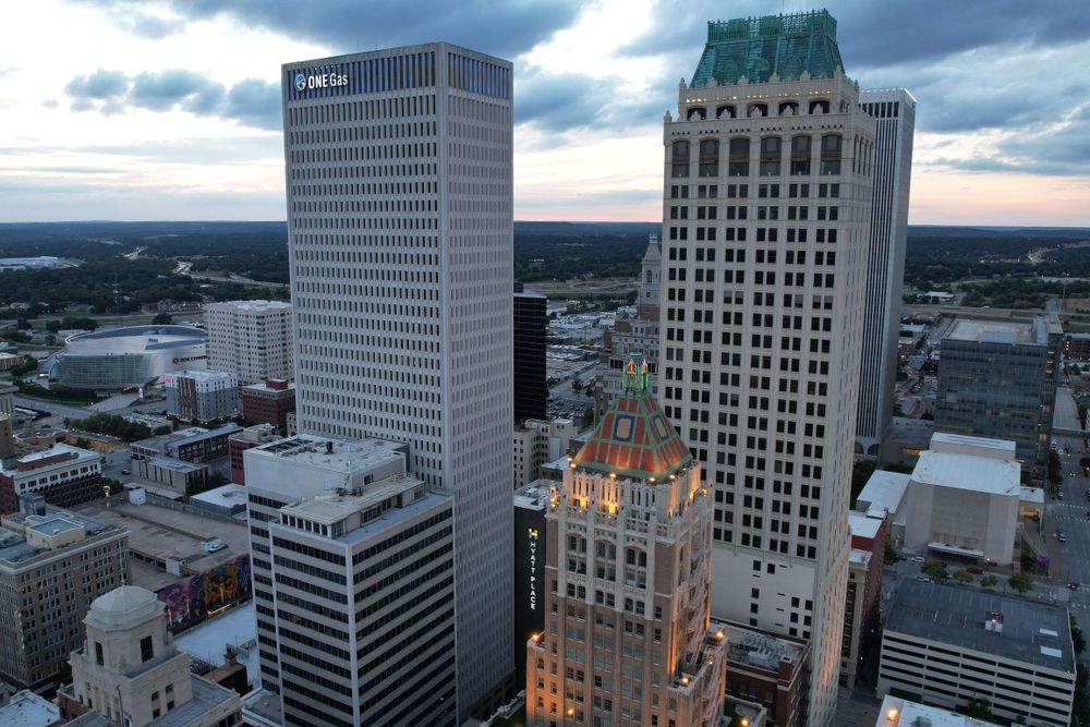 Aerial view of Tulsa cityscape with prominent ONEOK Building at twilight.