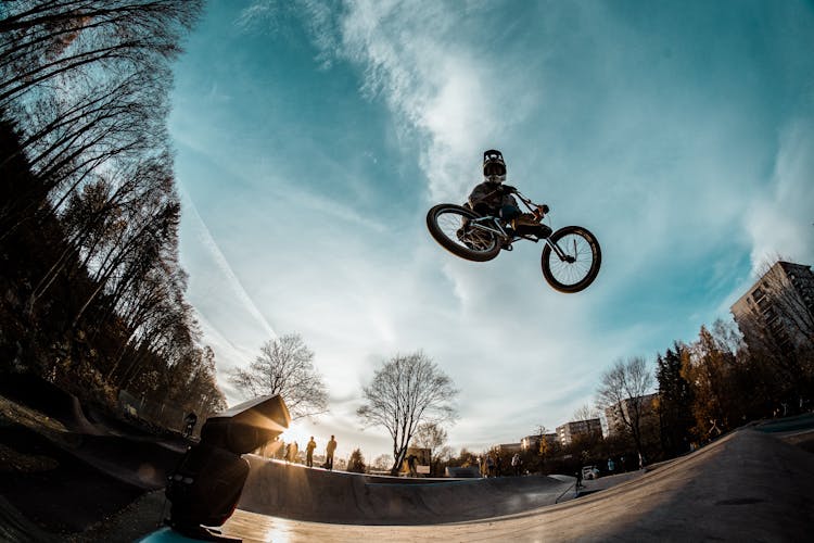 Person Riding Bike While In Mid Air In Skate Par