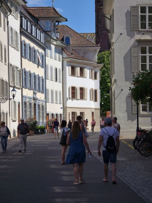 Free People strolling down a picturesque street lined with classic European architecture. Stock Photo