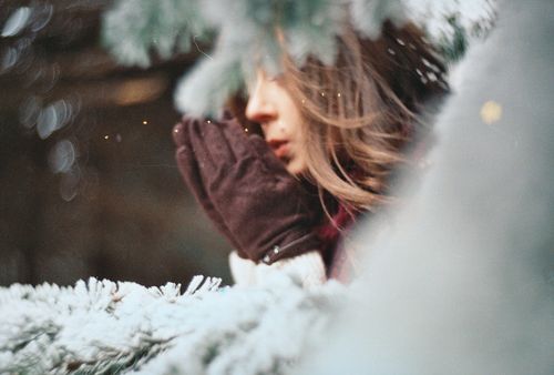 Free A woman wearing brown gloves embracing the winter chill amidst snow-covered surroundings. Stock Photo