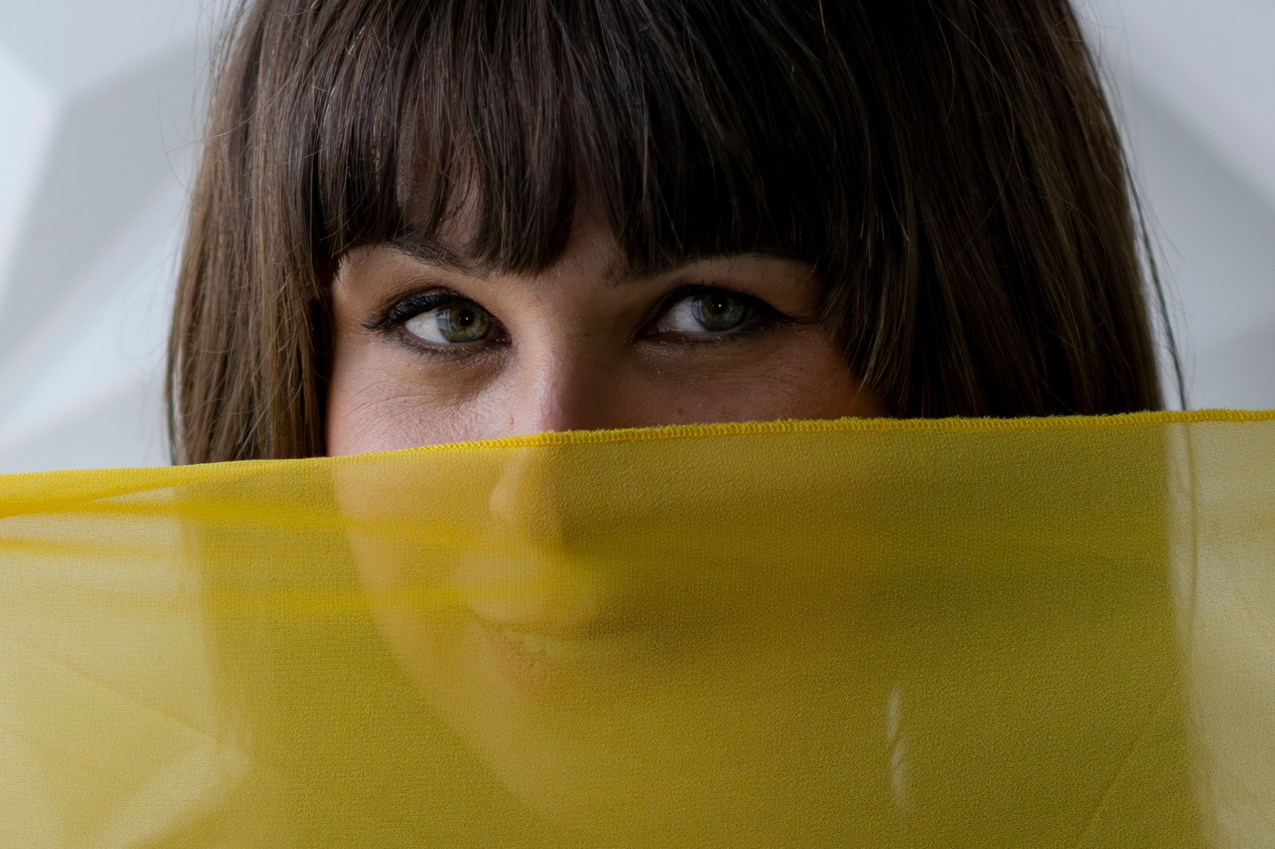 Portrait of Woman Partially Concealed by Yellow Fabric · Free Stock Photo