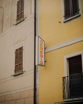 Weathered facade of a European building featuring shuttered windows and a sign reading 'CERESIO'.