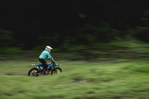 Free Motorcyclist performs high-speed dirt biking on an outdoor track, captured in motion. Stock Photo