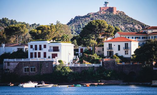 Free Charming coastal village in the Mediterranean with a hilltop lighthouse and serene atmosphere. Stock Photo