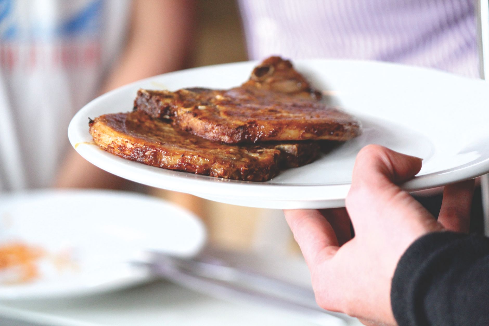 Plate of glazed porterhouse pork chops with char and caramelized crust