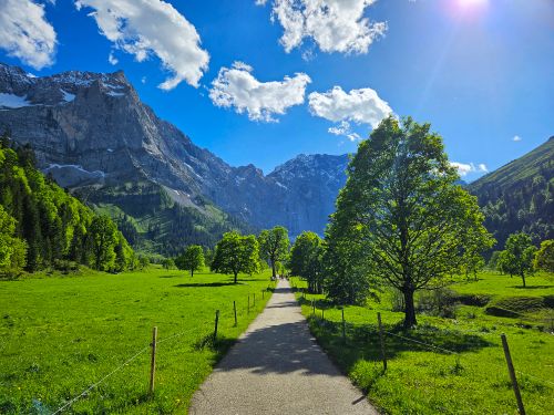 Free Beautiful spring landscape in Hinterriß, Austria, featuring the Karwendel Mountains under a bright blue sky. Stock Photo