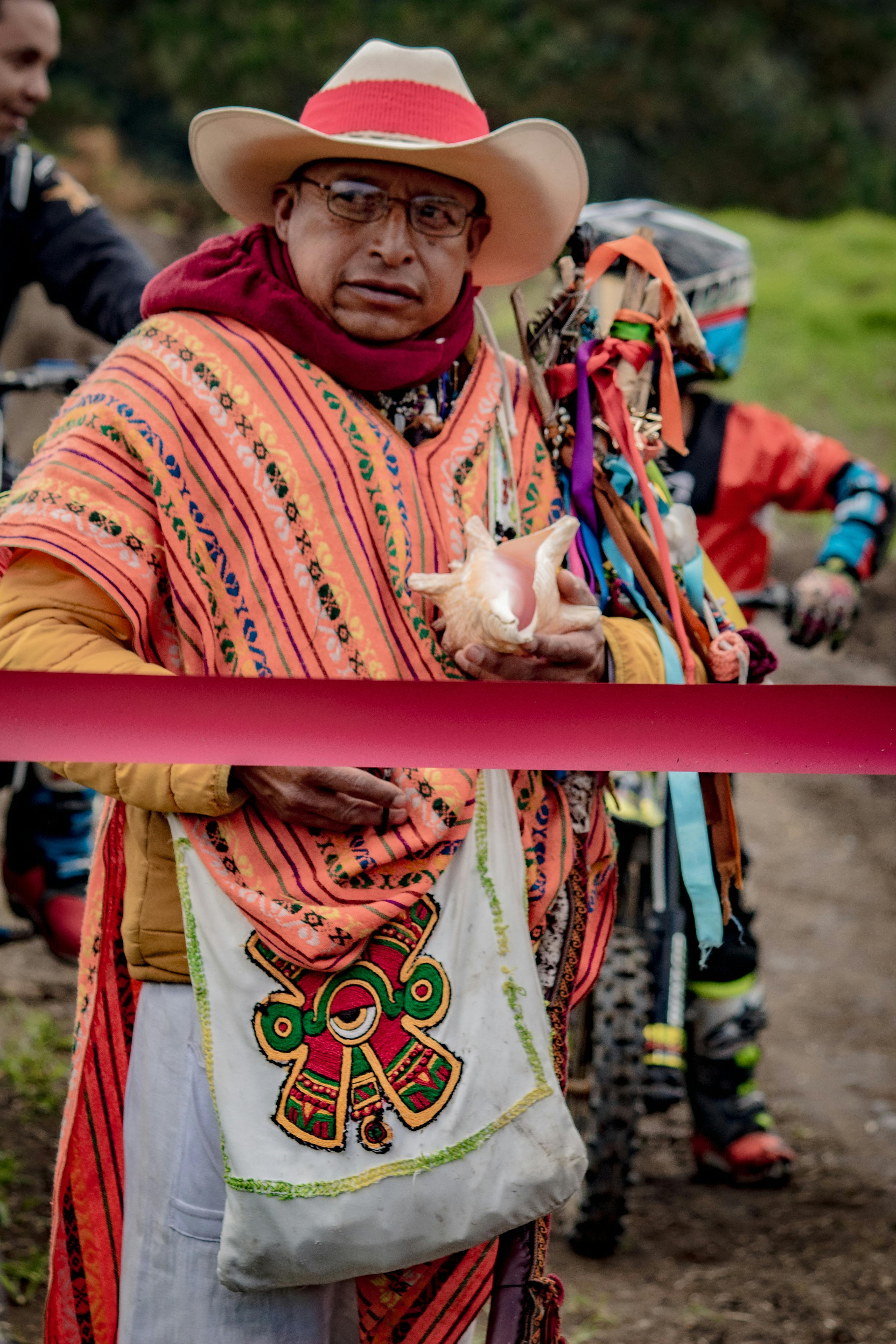 Indigenous man in traditional attire during a vibrant ceremony at La Marquesa, Mexico.