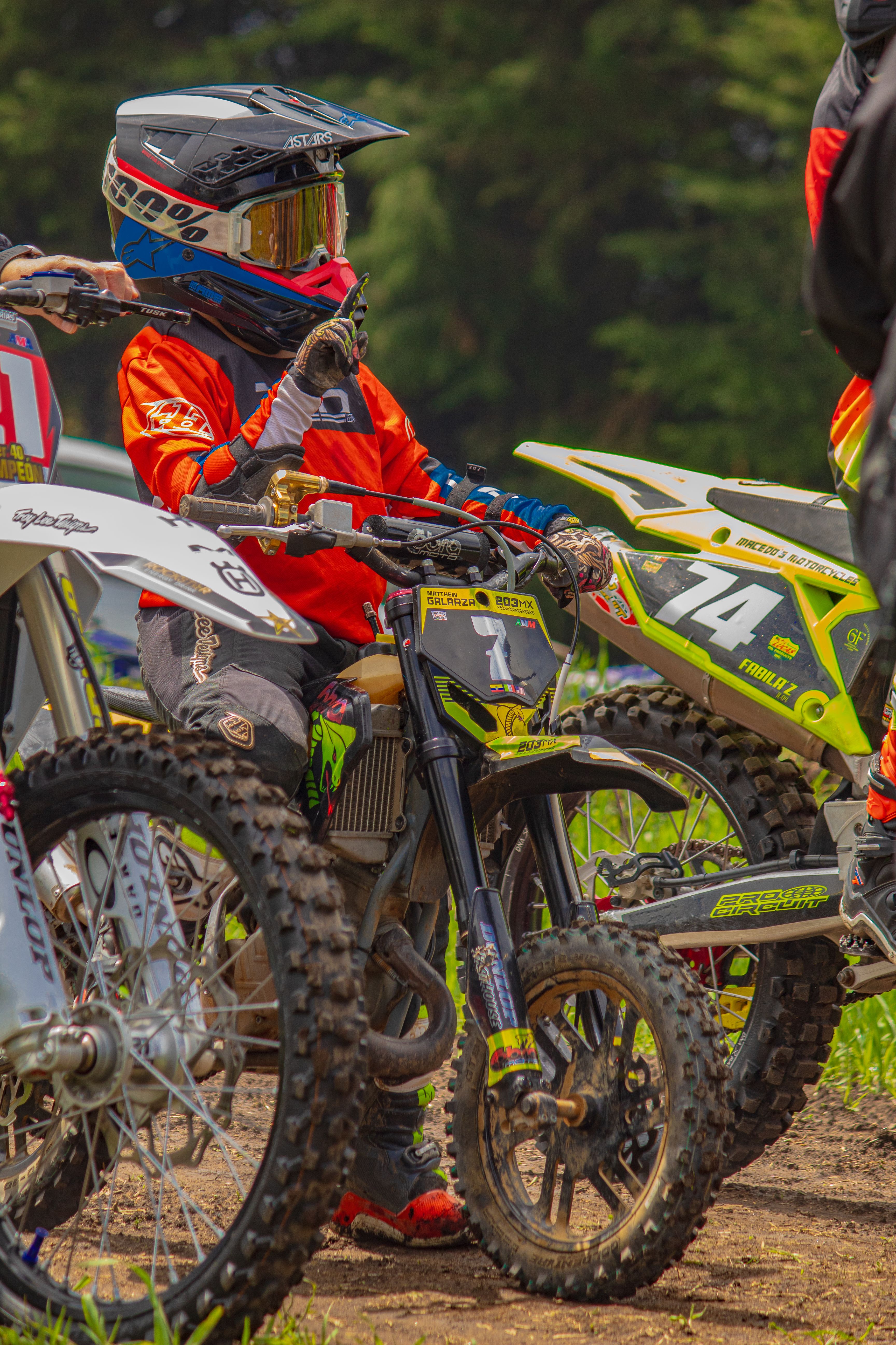 A young motocross racer prepares at a track in La Marquesa, Mexico, showcasing determination and focus.
