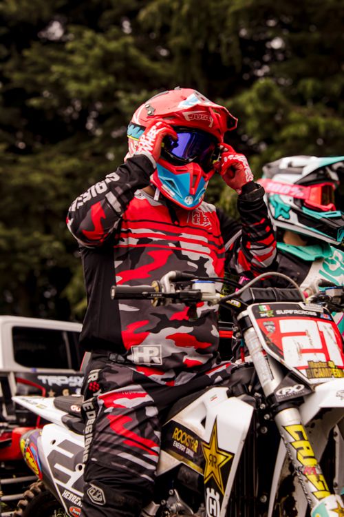 Free Motocross racer adjusts helmet, ready for competition in La Marquesa, Mexico. Stock Photo