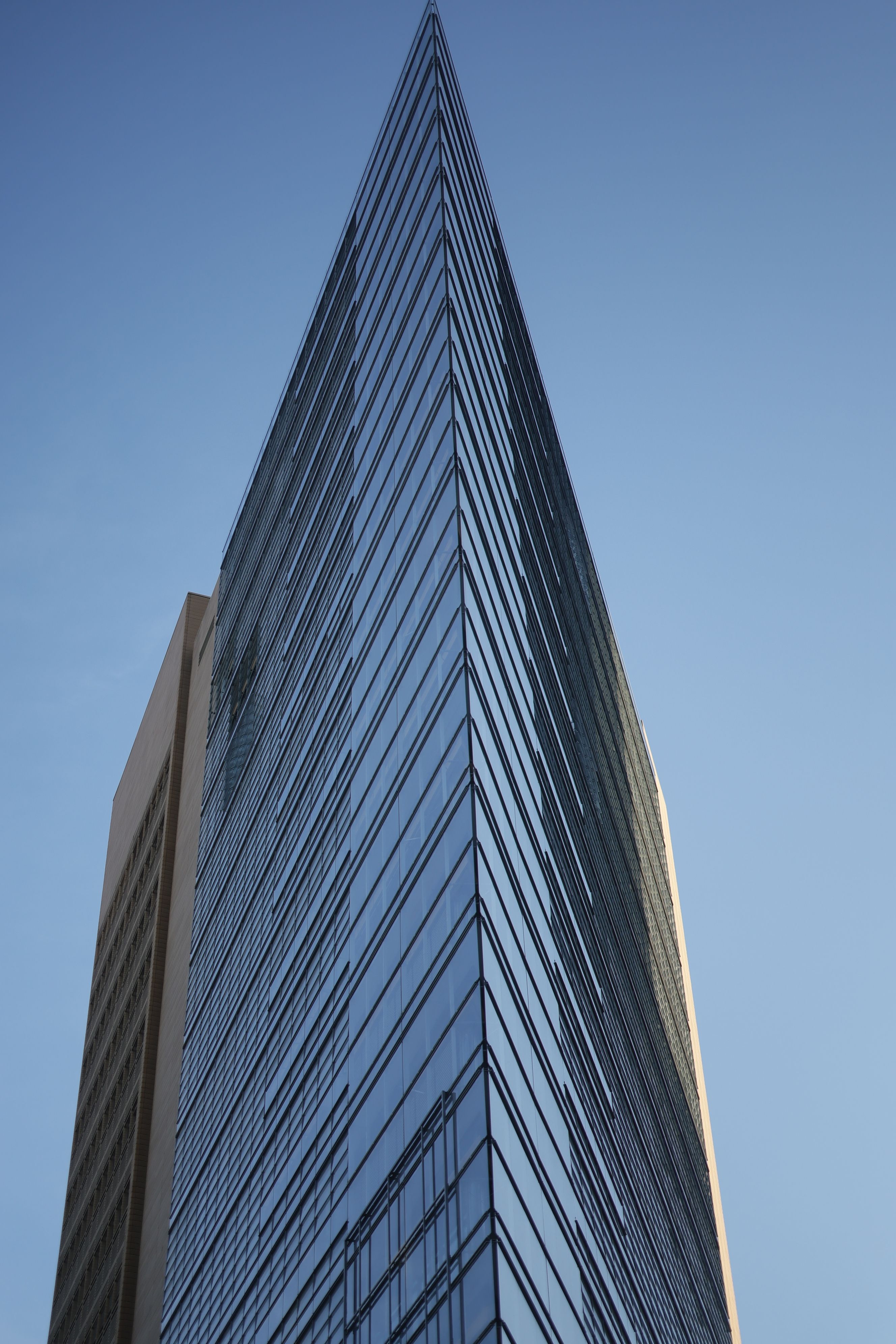 Modern Glass Skyscraper Against Clear Blue Sky · Free Stock Photo