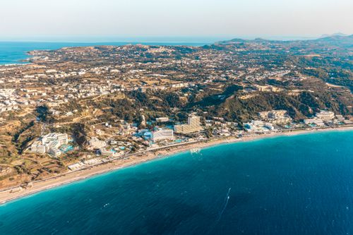 Free Breathtaking aerial shot of a coastal city in Rhodes, Greece, featuring stunning beaches and blue seas. Stock Photo