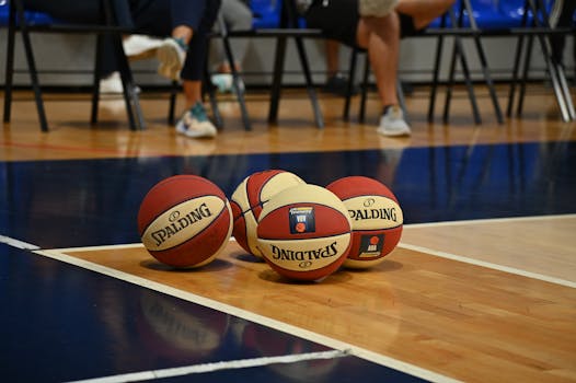 Multiple basketballs on the court during a game in Podgorica, Montenegro.