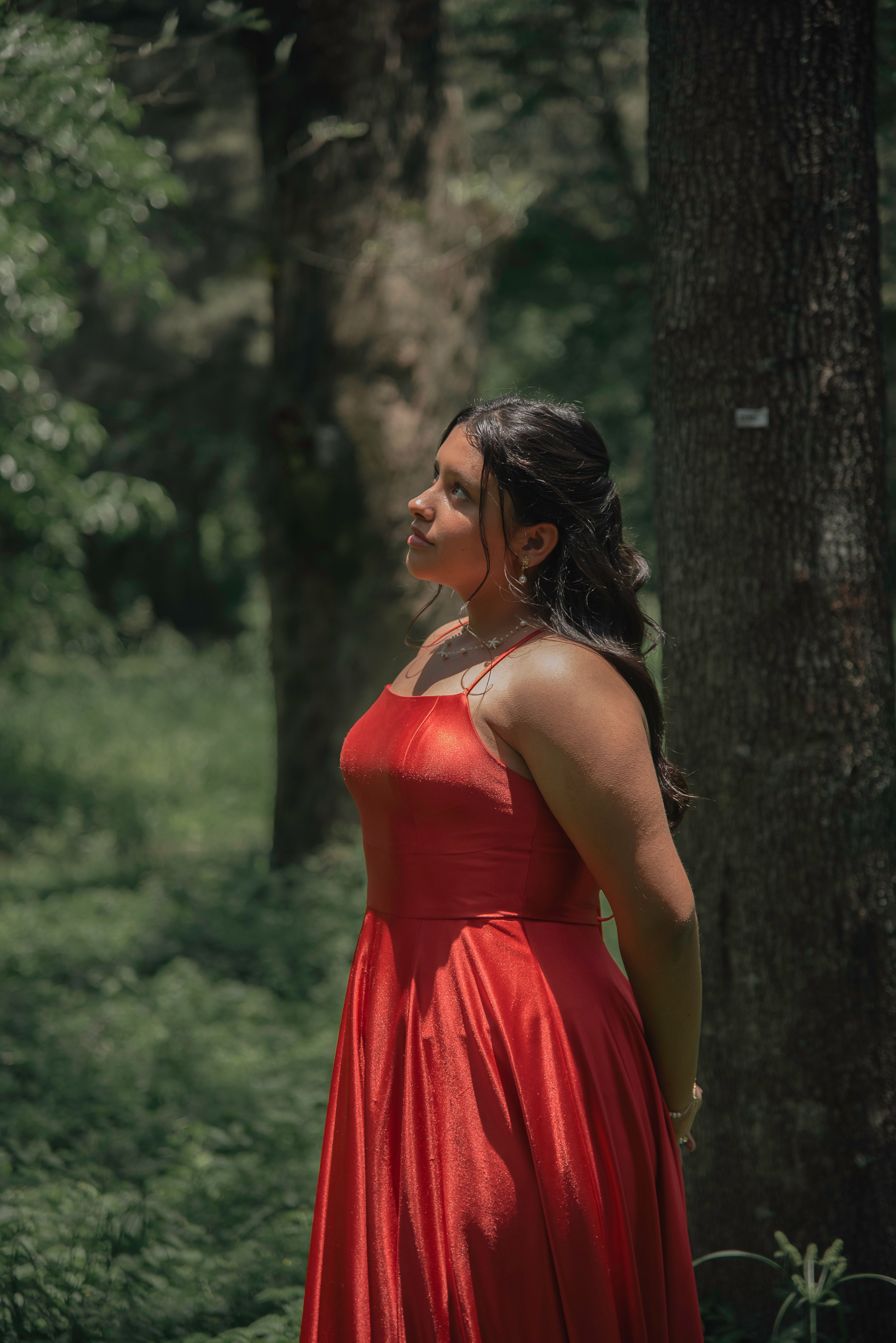 Elegant Woman in Red Dress Amid Forest Serenity  Free Stock Photo