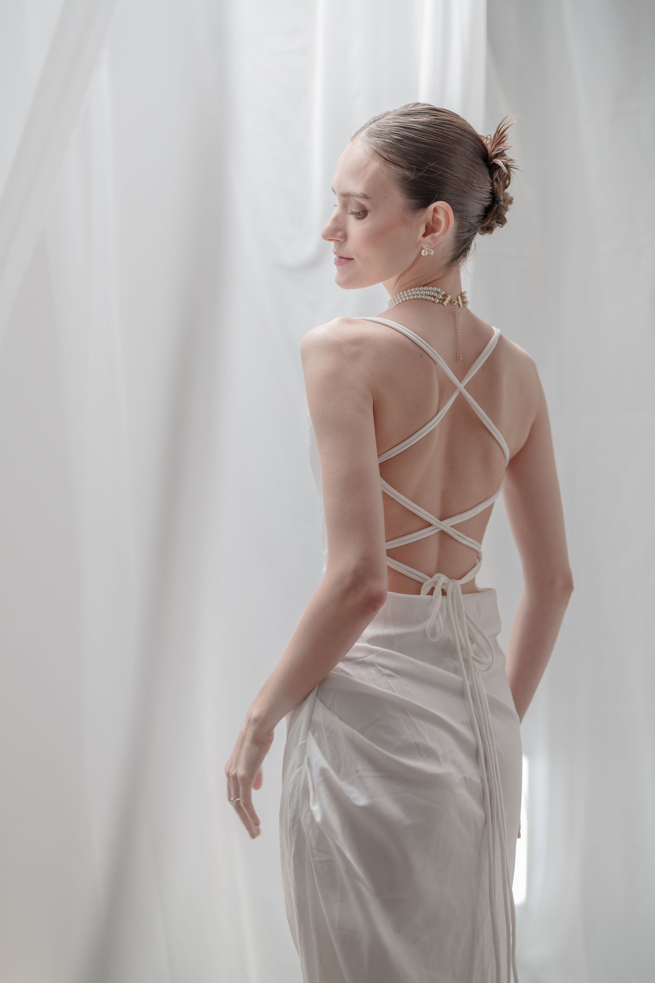 Elegant Woman in Backless Dress by Curtains · Free Stock Photo