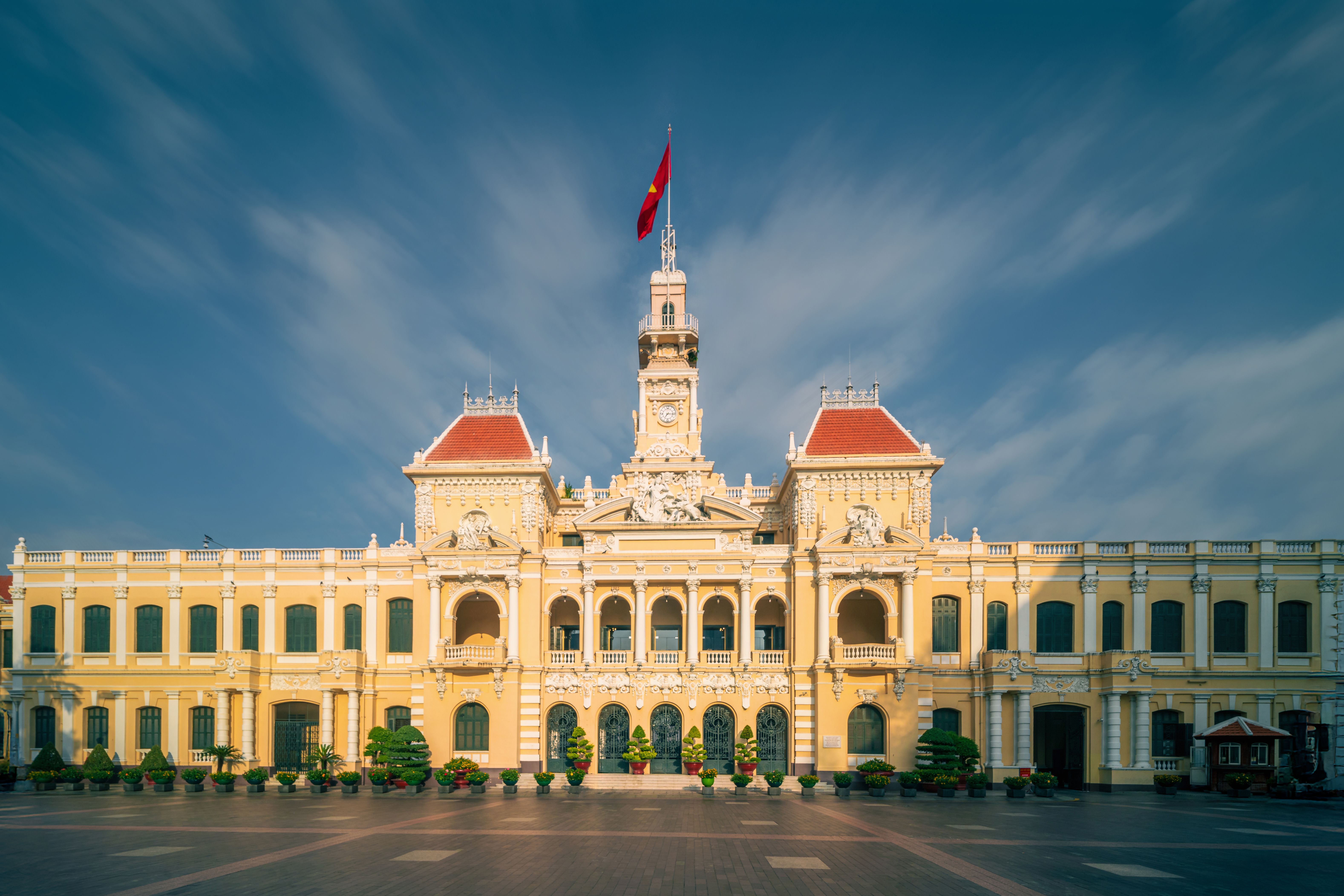 Front view of the historic Ho Chi Minh City Hall in Vietnam with a clear sky.