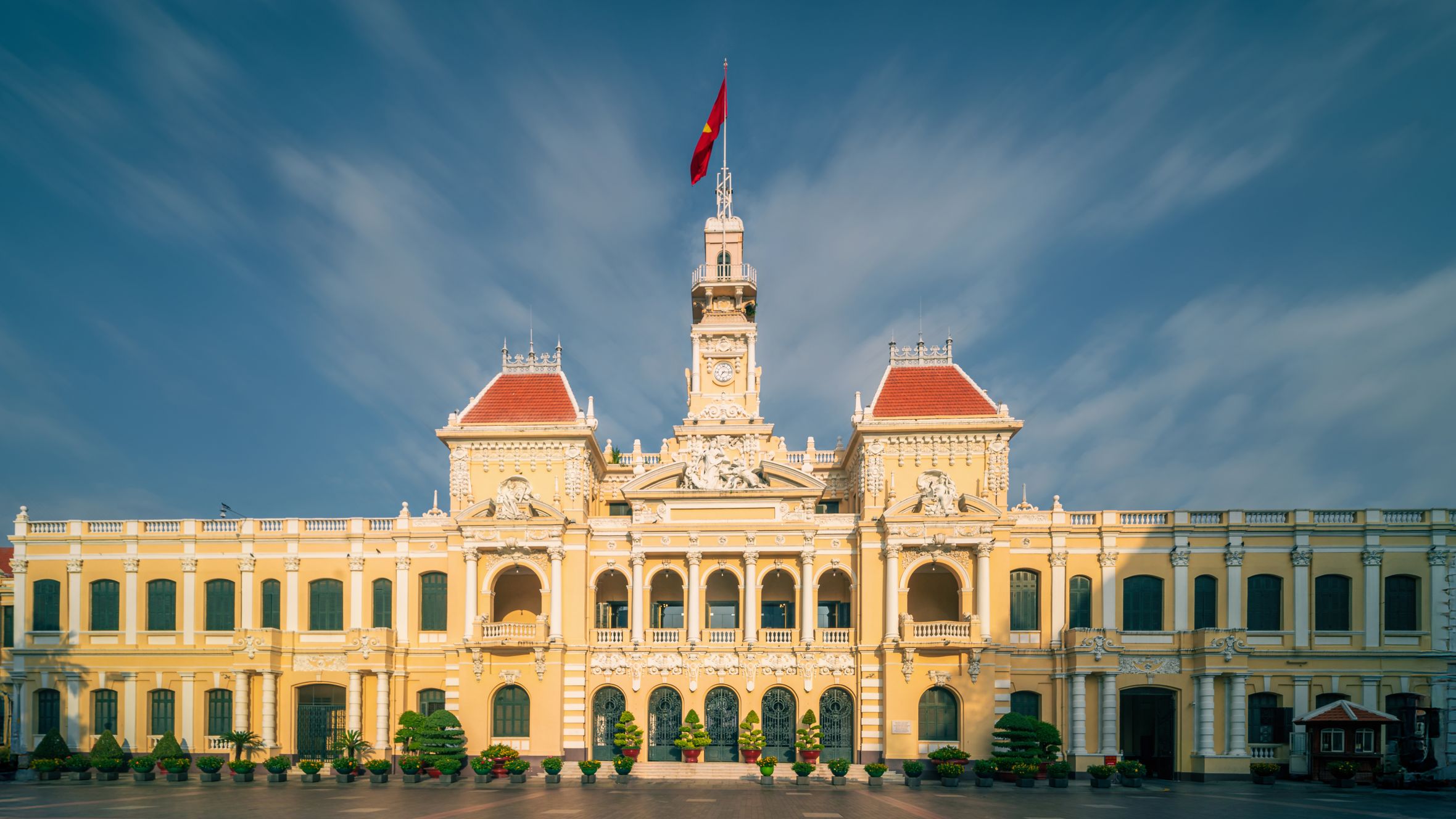 Front view of the historic Ho Chi Minh City Hall in Vietnam with a clear sky.