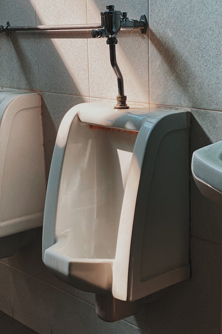 Shallow Focus Photo Of White Ceramic Urinal Bowl