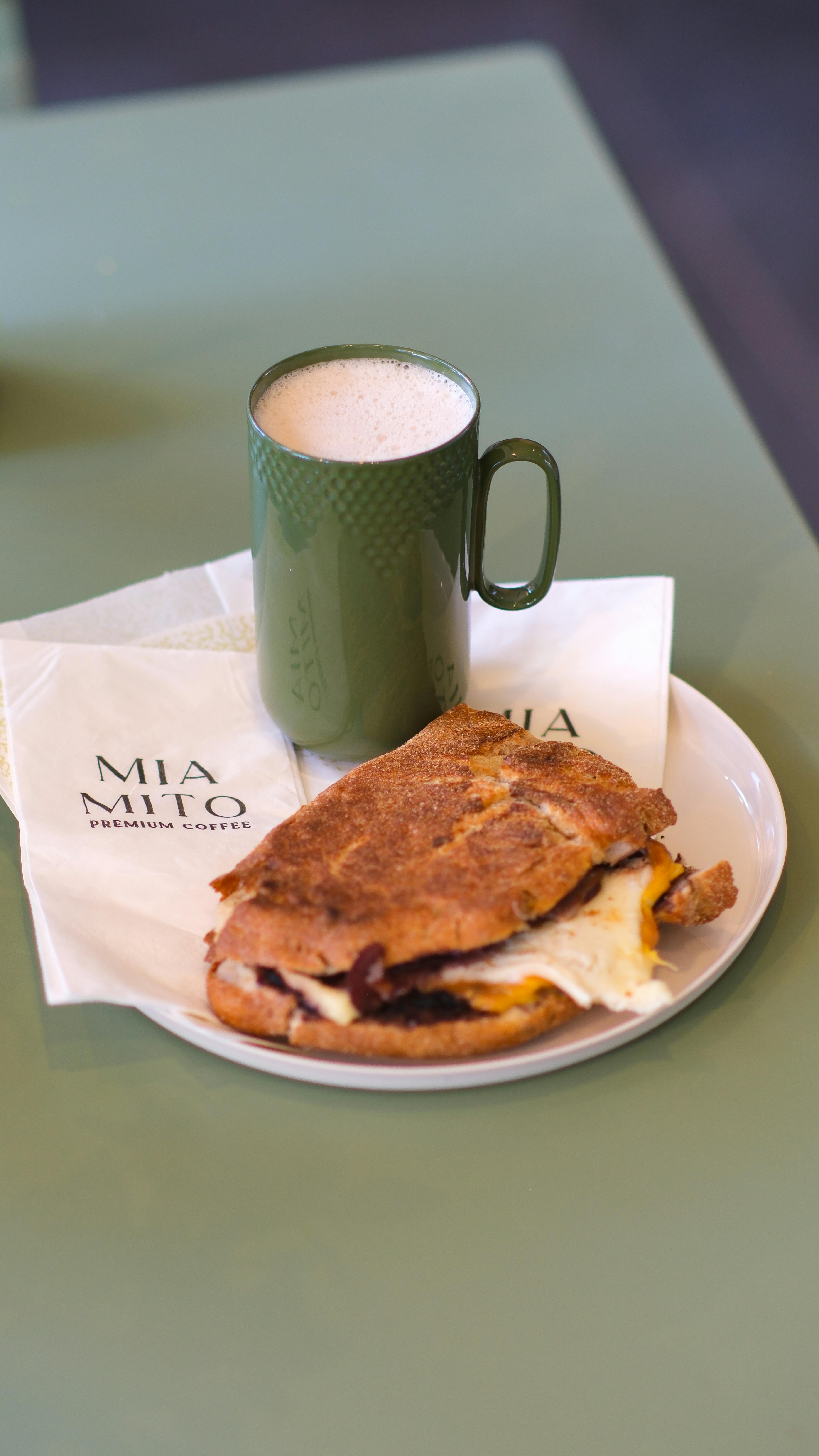 Enjoy a hearty breakfast sandwich and coffee at MIA MITO, a cozy cafe in Ankara, Turkey.
