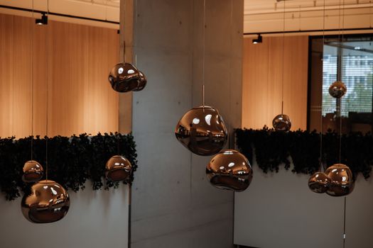 Stylish indoor scene featuring abstract metal pendant lights creating a warm ambiance.