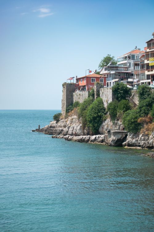 Free Charming coastal cliff view with colorful buildings in Sozopol, Bulgaria under a clear sky. Stock Photo