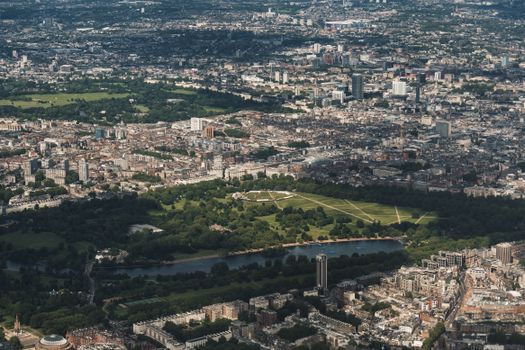 A stunning aerial view of London's skyline featuring lush parklands and urban architecture.