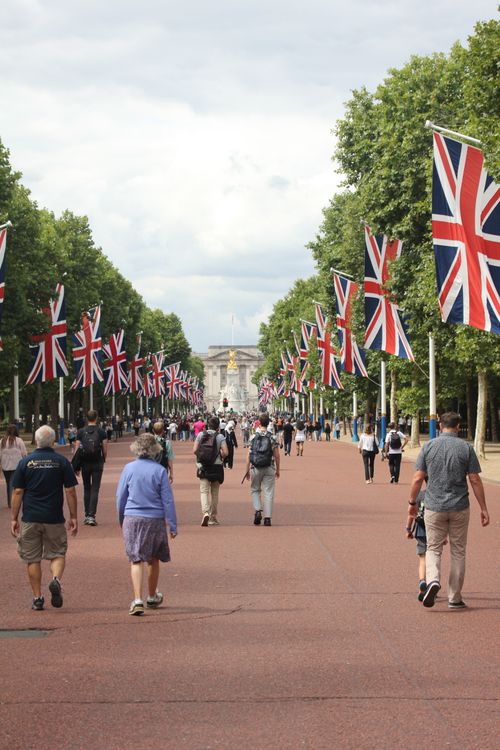Free A lively scene on The Mall in London with people walking under Union Jack flags. Stock Photo